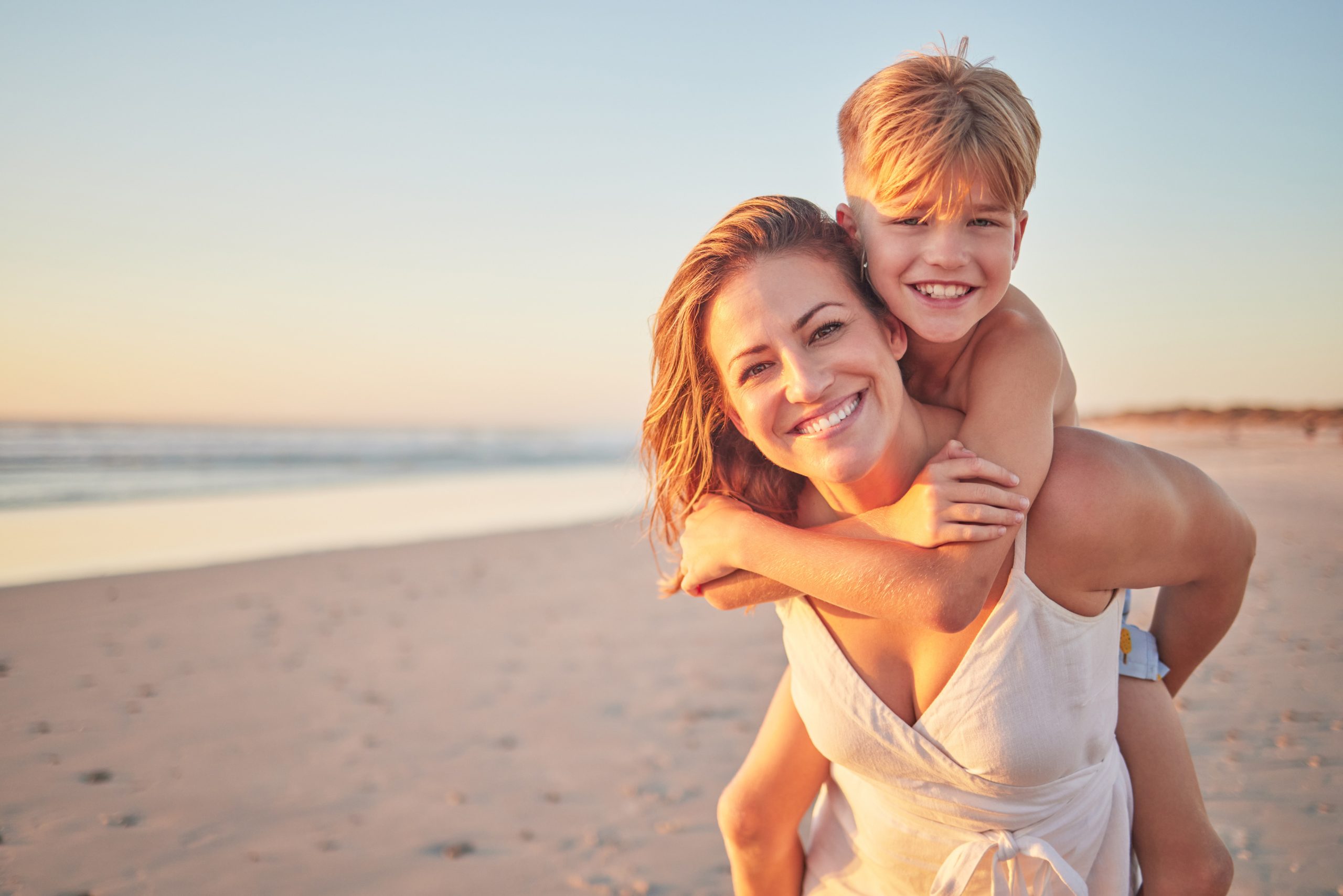 Mom, piggyback kids and portrait at beach holiday, summer vacation and ocean relax together for fun, freedom and quality time in Australia. Happy mothers day, excited boy children and sunshine sea.